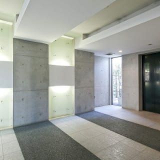 エレベーターホール／共用スペースはゆったりとした広さをとり、贅沢な仕様に。ガラスや御影石など内装材も厳選し、照明も駆使して洗練されたデザインに仕上がった