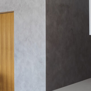廊下からLDKまで続くベネチアンスタッコの壁面。光の当たり方で印象が変わるため、なるべく広い面で使おうとこの場所を選んだ。木製の引き戸は寝室につながる
