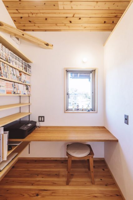 2 階、コンパクトで使いやすい書斎。壁面の本棚は収納力抜群。山桜を用いたカウンターに はゆとりがある