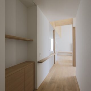 1階ホールからLDK方向を見る。画像左、ダイニングテーブルの一部を延長し手摺りとしている