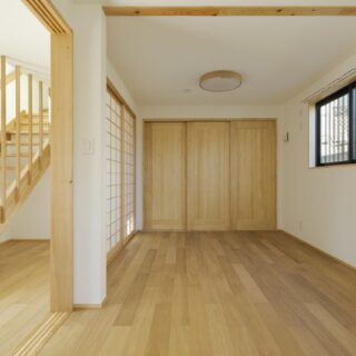 1階子ども室。障子を全開放すれば庭に面した玄関ホール（写真左側）とひと続きになる。庭や玄関ホールのおかげで外部の視線は子ども室まで届かず、カーテンを開けたままのびのびと遊べる