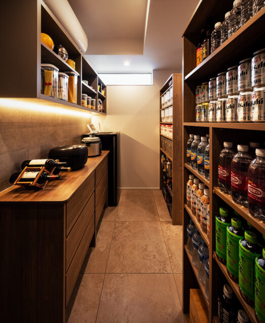 パントリー。撮影位置の左に洗濯機があり洗濯室を兼ねている。来客も使用する洗面脱衣室から生活感を排除