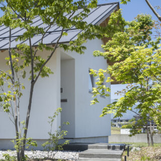 ゆるやかなステップをのぼって玄関へ。緑に彩られたアプローチに心が和む