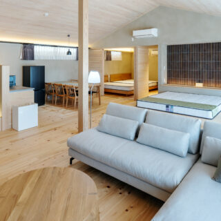 玄関方向から全体を見渡す。玄関を入ると上質な素材にあふれた大空間が広がり、特別な時間の始まりを期待してしまう。A棟は、内装のタイルなどの色合いをすべて変えたという。「リピートでいらしたときに違うお部屋にお泊りいただくのもいいですね」と大類さん
