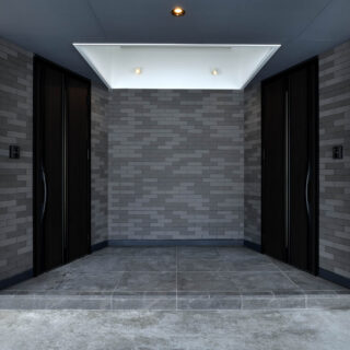 中央にある共有のエントランスは、天井が吹き抜けとなっていて、光が降り注ぐ。親世帯・子世帯で独立した玄関をもつ、完全分離型二世帯だ。