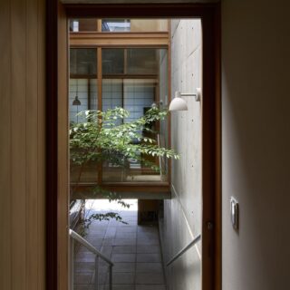 1階親世帯の玄関前から外階段を見下ろす。中庭を挟んだ正面には、親世帯のダイニングが見える