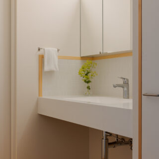 洗面室は、脱衣所から独立させることで、浴室の湿気が漂わない。またパブリックな場所にできるため、来客時も利用しやすい。下部を収納とせずオープンにすることで、お掃除ロボットの基地にもなっているという。