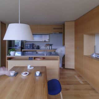 キッチン（写真奥）はオリジナルで造作。写真左に進むとパントリーがあり、買い置きの食材やキッチン雑貨を保管できる。このキッチン・ダイニングはランドリールームなどを集めた水まわりに行きやすい場所にあり、家事動線も良好