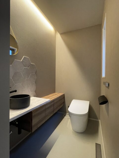 落ち着いた雰囲気のトイレ。奥様が選んだという六角形のタイルが良いアクセントに。