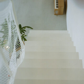 階段は手すりを極力少なく、網で落下防止に。こうすることで閉塞感をなくし、上階からの光が下へ降り注ぐ。